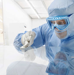 Workers wearing cleanroom garments in sterile facility